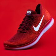 unpaired red Nike sneaker